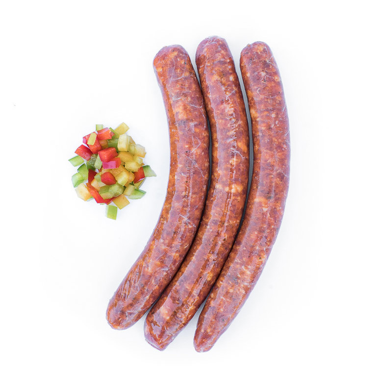 La piquante, saucisse au piment d'Espelette. Maison Alpin. Vente en direct de la salaison familiale. Charcuterie artisanale, saucisson, saucisse, diot, jambon, de Haute-Savoie & viande de qualité supérieure en ligne.